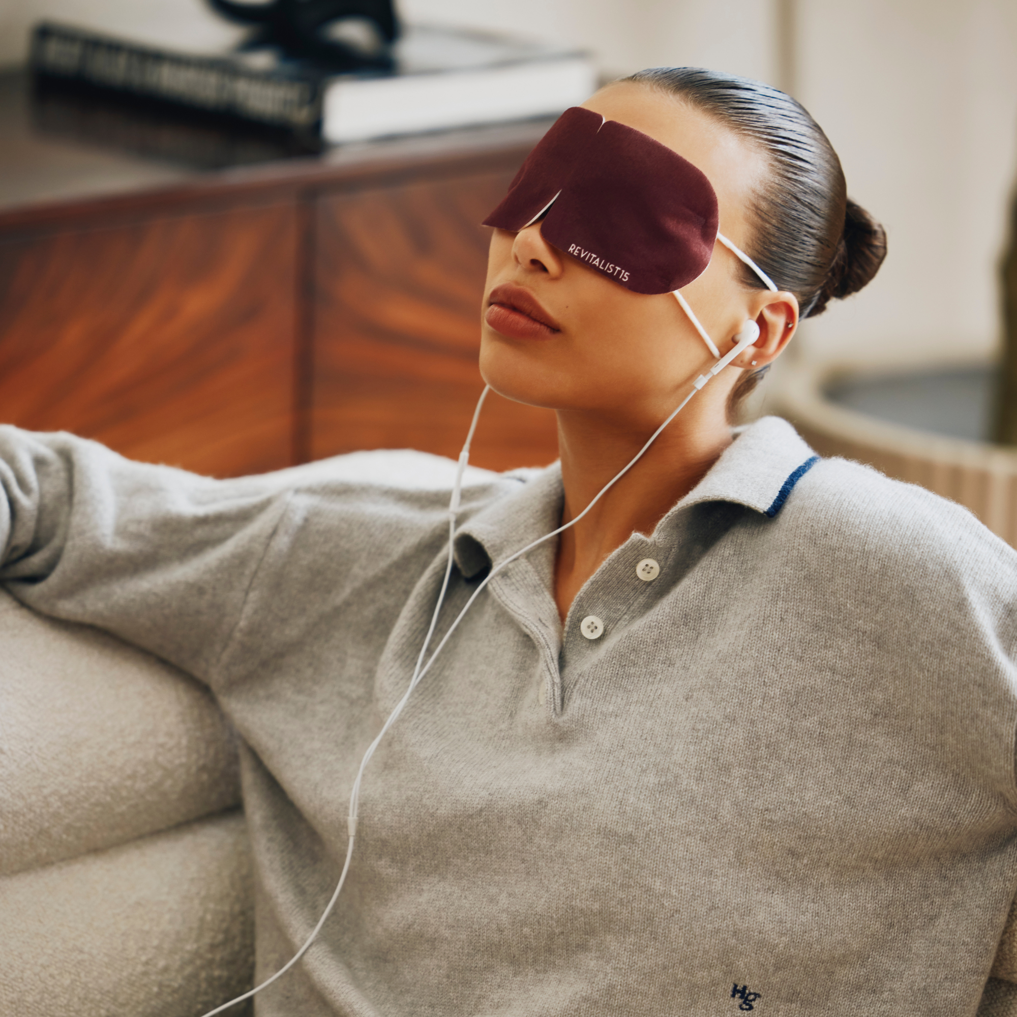 Woman wearing Revitalist15 self-heating eye mask during a midday break to relieve eye strain and tension