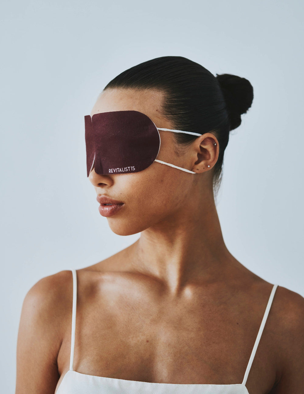 Woman wearing the Revitalist15 self-heating eye mask, embodying rest, warmth, and modern Japanese-inspired calm.