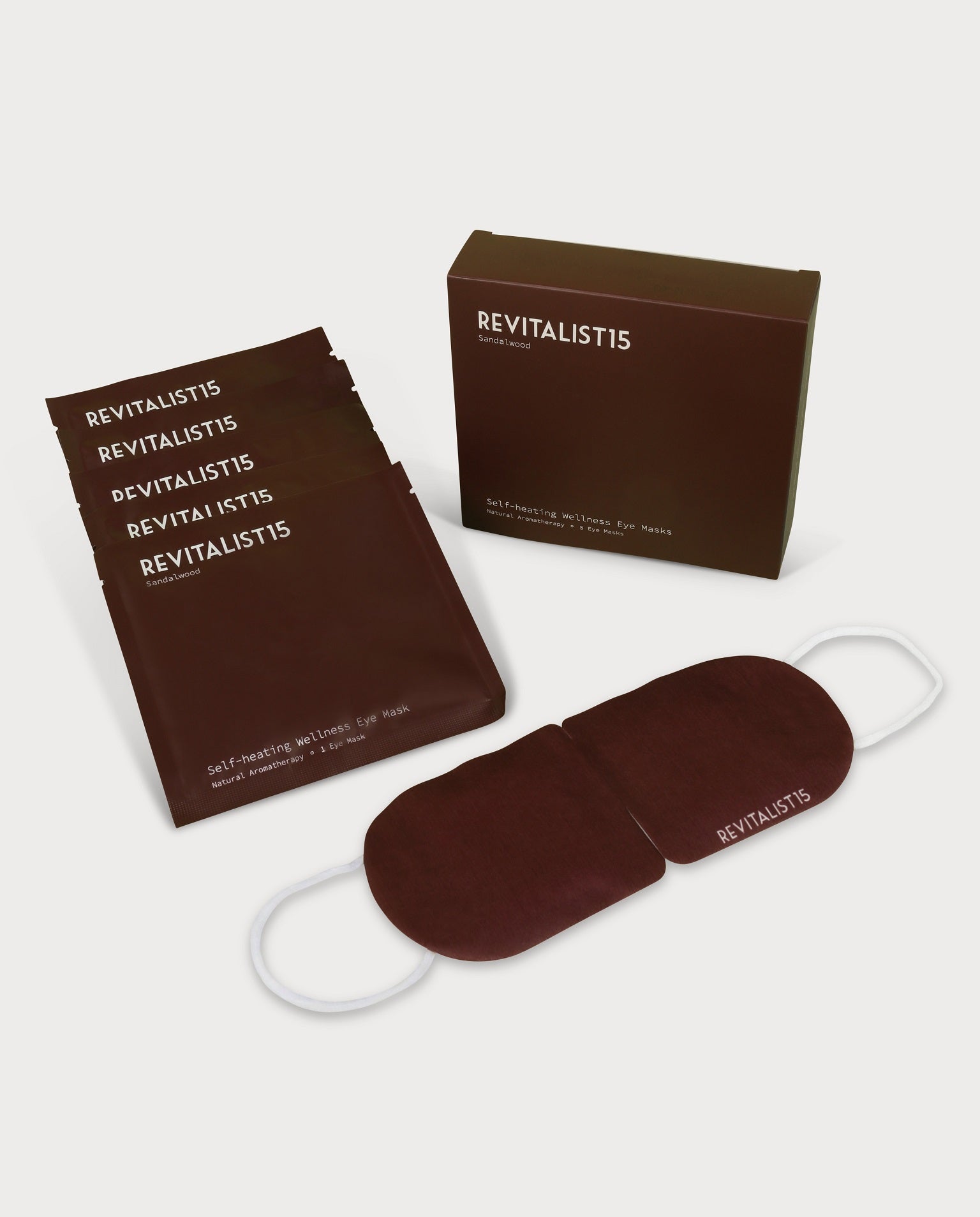 Revitalist15 self-heating sandalwood eye mask and packaging displayed on a white background, representing calm and restorative rest.